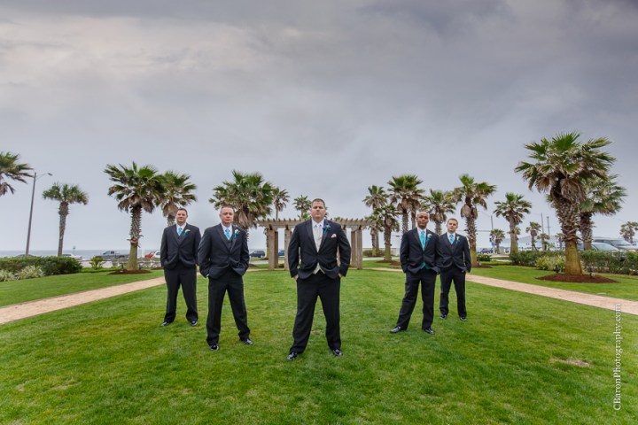 C. Baron Photography; Casablanca lilies; Cinderella cake; Couple; Galveston Wedding Photographer; Hotel Galvez; Houston Wedding Photographer; Music Hall; Spring; Strapless; Texas; blue; blue galaxy orchid; bride; confetti; dendrobium; first look; galveston; groom; lace; purple; rain; reception; sand; seawall; ceremony; singapore orchid; teal; 