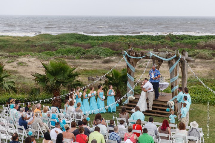 Aqua; Beach House; Beach Photographer; Beach Wedding; Blue; Bolivar Peninsula; C. Baron Photography; Crystal Beach; Crystal Beach Weddings; Galveston County; Galveston Wedding Photographer; Houston Wedding Photographer; Paper flowers; Tropical theme; Turquoise; barefoot; beach; brooch; coral; ferry; fireworks; gulf; lace gown; ocean; sand; sand dunes; sandals; sea; seashells; sunglasses; updo; waves; wayfarers; 