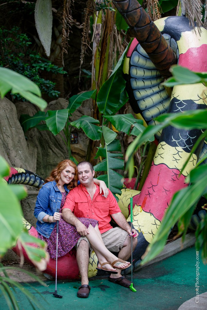 C. Baron Photography; Galveston; Galveston Engagement Photographer; Houston Wedding PHotographer; Jean Jacket; Texas; couple; engagement session; mini-golf; outdoors; putt-putt; summer; tree; 