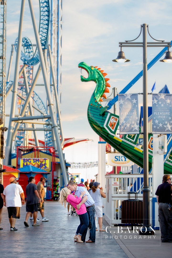 Beach; C. Baron Photography; Carnival; Couple; Engagement session; Galveston; Galveston Engagement Photographer; Galveston Island; Galveston Wedding Photographer; Houston Wedding Photographer; Pleasure Pier; Rides; Seawall; Texas; Texas Wedding Photographer; boardwalk; carousel; roller coaster;
