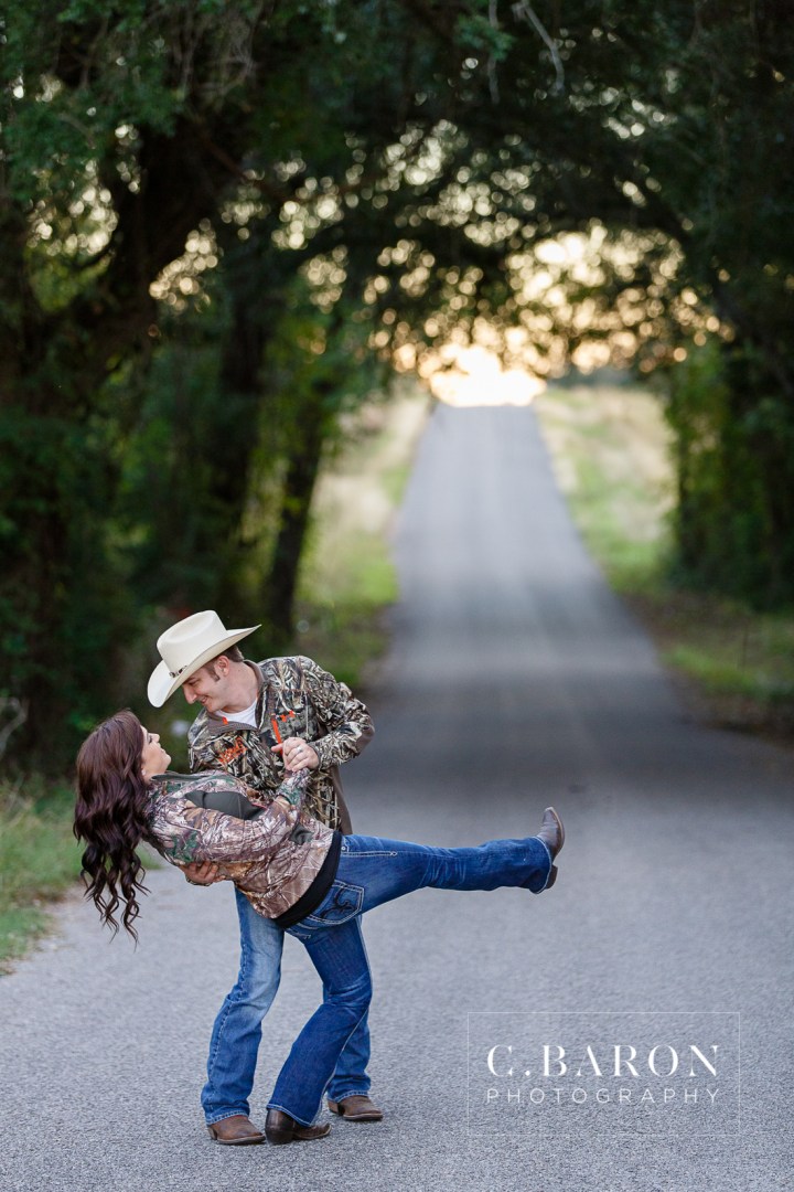 '32 Ford, Brenham Engagement Photographer, C. Baron Photography, camo, Country, Couple, cowboy hat, donkeys, Engagement session, farm, Fence, Grass, hills, Houston Engagement Photographer, John Deere Tractor, Old Oaks, sunset, Texas