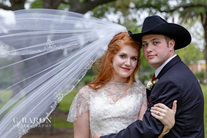 Beaded capelet; C. Baron Photography; Central Christian Church; Galveston; Galveston Wedding Photographer; Garten Verein; Gold; Groom; Historical building; Horse Carriage; Impression Bridal; Island; Red Roses; Rose Petal Leave; Spring; Texas; blush lace gown; bride; cowboy hat;